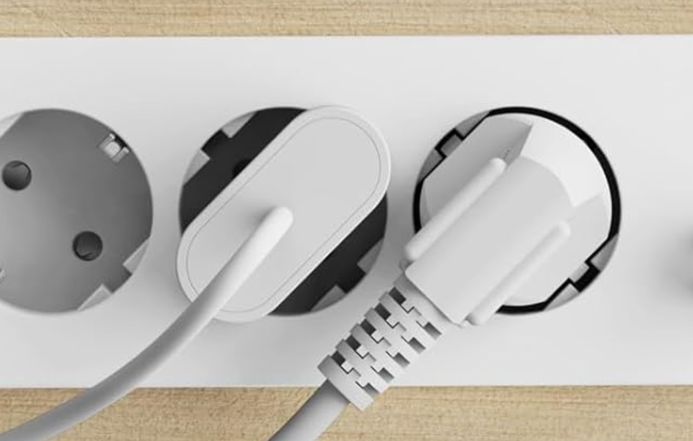 a clearly-photoshop image of a power strip with a europlug plugged in the wrong way round in its shuko hole (i.e. with the power pins not anywhere near the actual contact holes)